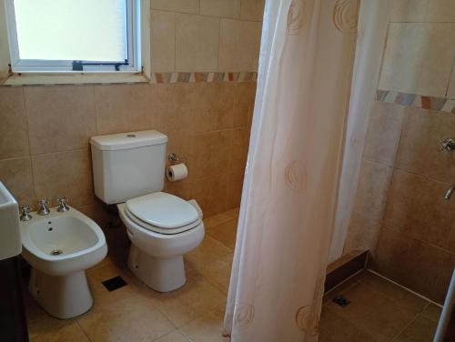 a bathroom with a toilet and a sink and a shower at Casas Nahuilen in San Martín de los Andes