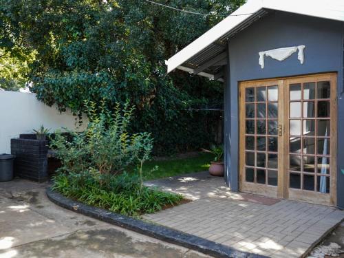 a small shed with a door in a yard at Leaf & Lark in Bloemfontein