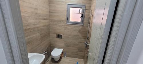 a bathroom with a toilet and a sink and a window at Villa in Ouled Yaneg in Ouled Yaneg