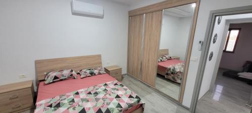 a bedroom with a bed and a large mirror at Villa in Ouled Yaneg in Ouled Yaneg