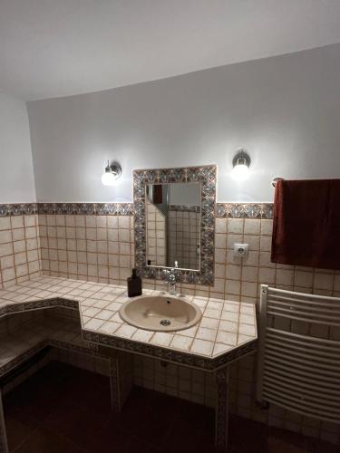 a bathroom with a sink and a mirror at La Salera - Casa Rural in Saelices de la Sal