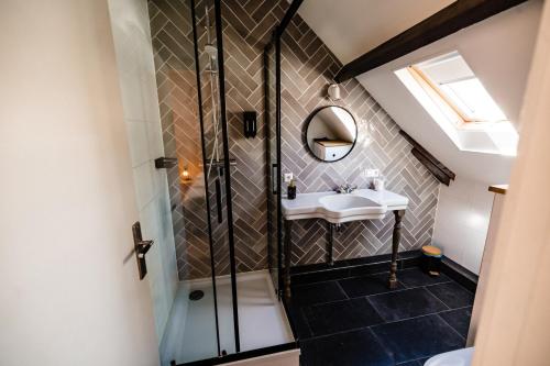 a bathroom with a shower and a sink at bijDorien in Gennep