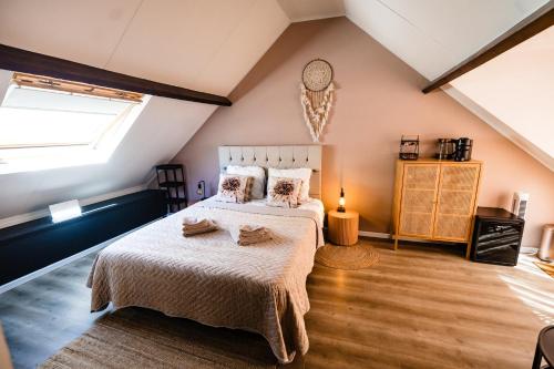 a bedroom with a bed and a window at bijDorien in Gennep