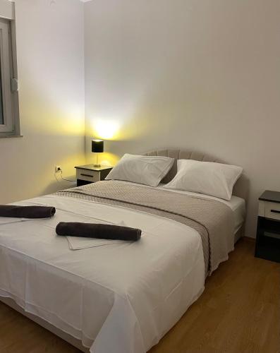 a bedroom with a large white bed with white pillows at Apartman LUXE STAY Vujović in Bileća