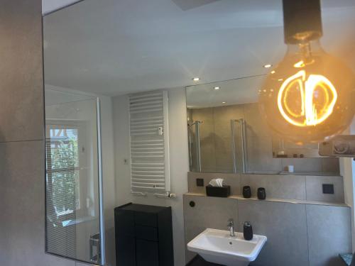 a bathroom with a sink and a mirror at Modernes Altstadtappartment Suite Plötze 13 Limburg in Limburg an der Lahn