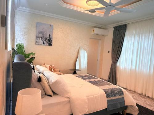 a bedroom with a bed and a ceiling fan at J-Ver Haven in Kasoa