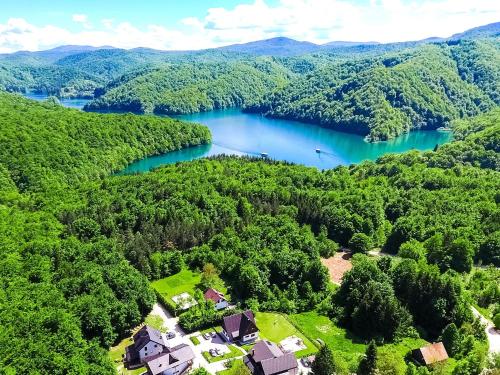 an aerial view of a lake with houses and trees at Plitvice Lower Lakes Rooms in Plitvica Selo