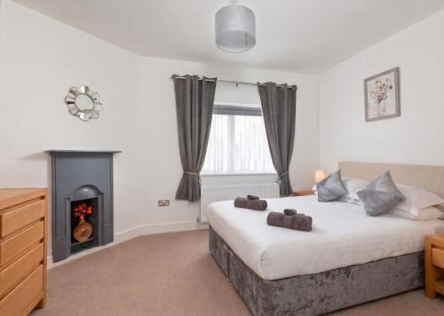 a bedroom with a bed and a fireplace at Four Oaks Cottage in Rockcliffe