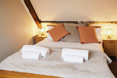 a bedroom with a bed with two towels on it at Whitby Old Town Stay, Sleeps 4, The Nest in Whitby