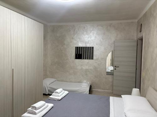 a room with two beds with towels on them at Il BORGO in Lapedona
