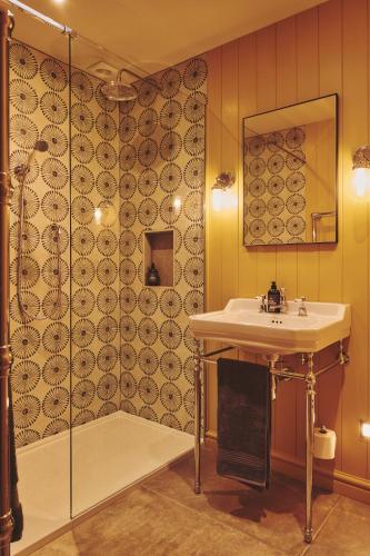 a bathroom with a sink and a shower at Haymill Retreat in Trefeglwys