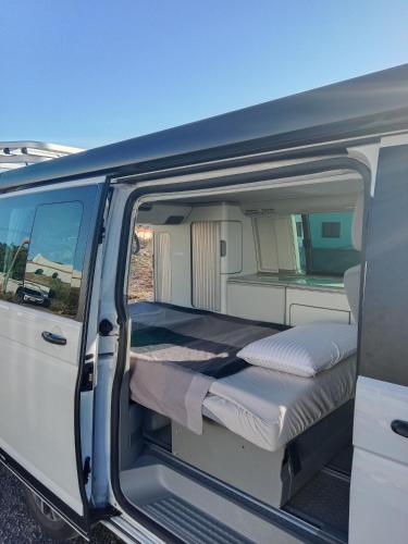 a white van with a bed in the back at Nomad Campers VW California in La Mareta