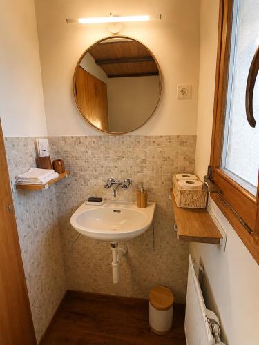a bathroom with a sink and a mirror at Chalet Montana mit Bergblick in Brunig