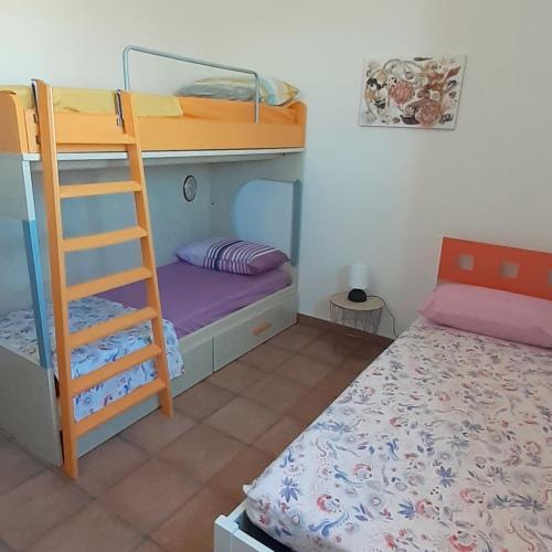 a bedroom with two bunk beds and a ladder at b&b Stella marina torre guaceto in Specchiolla