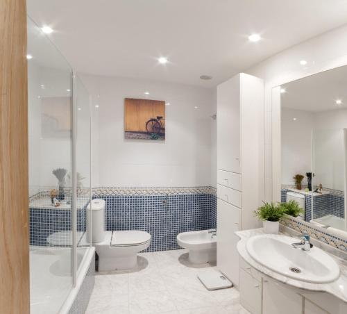 a bathroom with a toilet and a sink and a shower at AG Aiguablava Vista Mar in Playa de Gandia