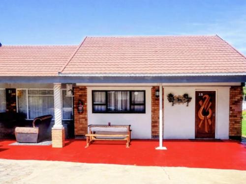 a house with a red floor and a red driveway at Schweizer Lodge in Schweizer-Reineke