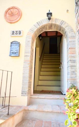 an entrance to a building with a staircase at La casa di Mastro Ivetto in Arcevia