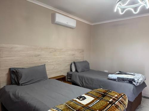 a bedroom with two beds and a ceiling at Northam Square Mine Contractor Accommodation in Northam