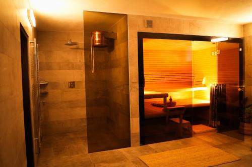 a bathroom with a shower with a table and a bench at Statek Český Dvůr in Postupice