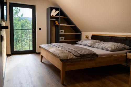 a bedroom with a bed and a stair case at Chata Vali in Loučovice