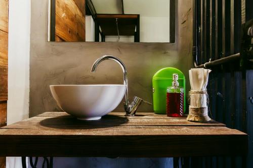 a bathroom counter with a bowl sink and a mirror at Go Hostel in Córdoba