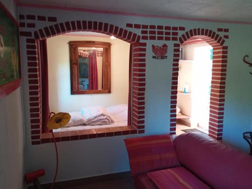 a room with a brick wall with a bed in it at WCB Bees in Saint-Vérain