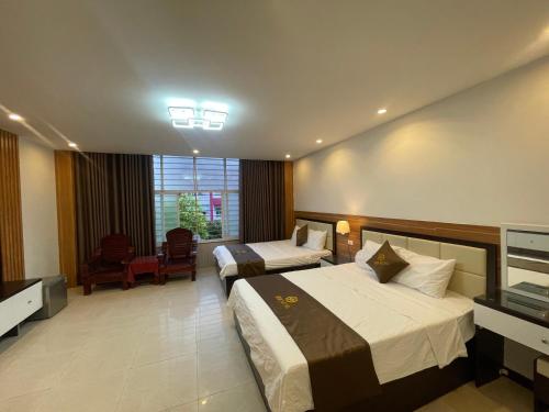 a hotel room with two beds and a window at G9 home hotel in Hanoi