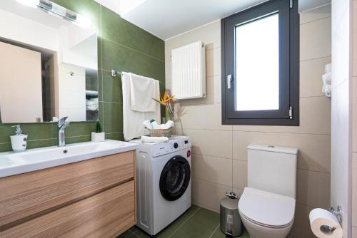 a bathroom with a washing machine and a sink at Lefkada Town Condo in Lefkada