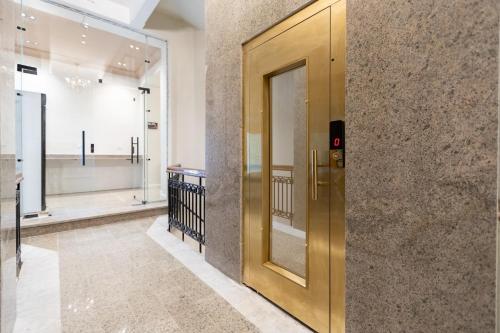 a golden elevator in a building with a hallway at Malak Palace Cairo Hotel in Cairo