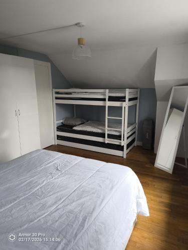 a bedroom with a white bed in a room at Les petits logis de l'Écluse in Noyers-sur-Cher