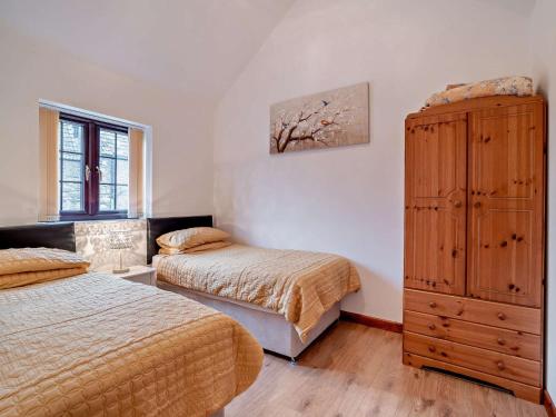 a bedroom with two beds and a dresser at 2 Bed in Bristol oc-72836 in Chew Magna