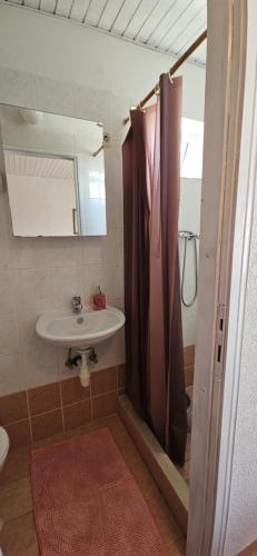 a bathroom with a sink and a shower at Sunny house KIMI in Omiš
