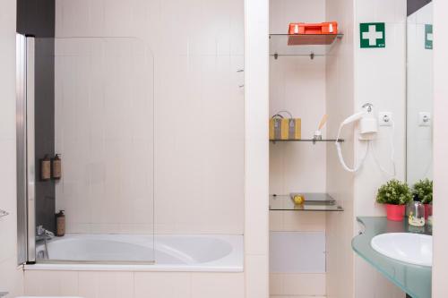 a bathroom with a tub and a sink at RH Charming Apartment - D Nuno in Barcelos