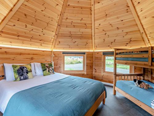 a bedroom with a bed in a wooden cabin at 1 Bed in Lanark oc-91248 in Libberton