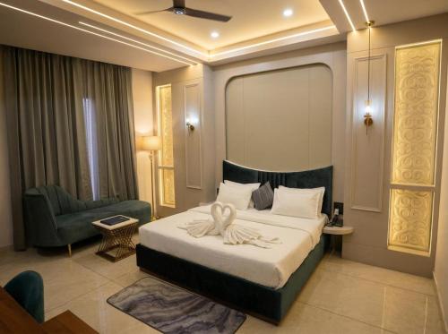 a hotel room with a bed and a chair at Thejaiparadise by jai hotel in Rohtak