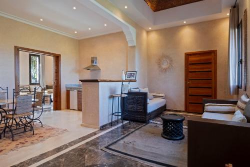 a living room with a couch and a table at Bab Akoul Atlas - Boutique Hotel & Spa in Aït Namous