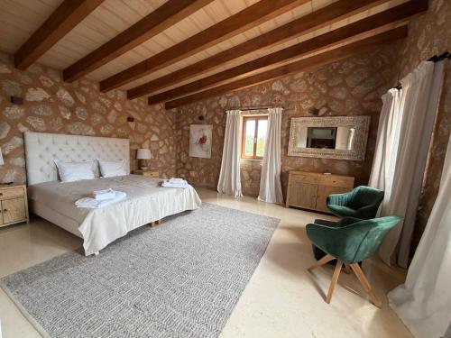 a bedroom with a bed and a chair and a television at Finca Latenéa in Islas Baleares