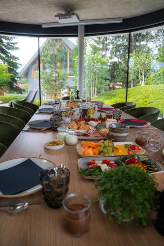 a long wooden table with food on it at Ambient Resort Bled in Bled