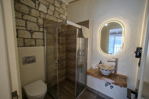 a bathroom with a shower and a sink and a toilet at Moranka by ALS ALAÇATI in Alaçatı