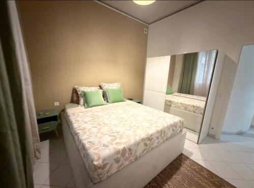 a bedroom with a bed with two green pillows at Monaco Cote d Azur in Beausoleil
