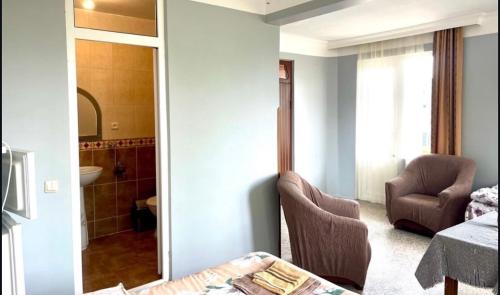a room with a mirror and a chair and a bathroom at HOTEL - SHORENA in Ureki