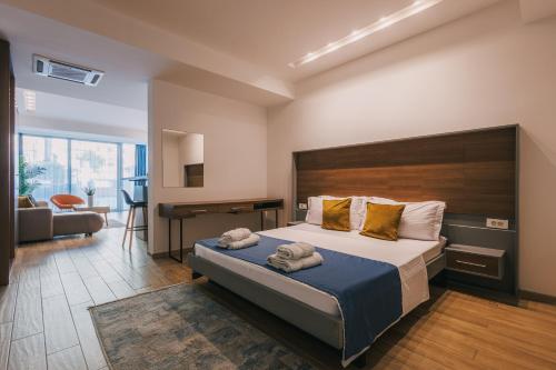a bedroom with a bed and a desk in a room at Atelier in Ulcinj