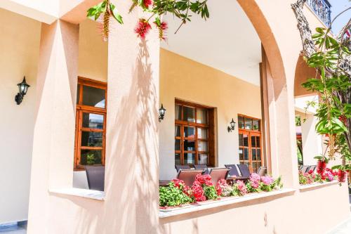 a row of chairs on a balcony with flowers at Philoxenia Hotel in Skala Prinou