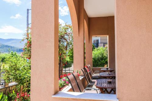 a row of tables and chairs on a balcony at Philoxenia Hotel in Skala Prinou