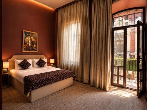 a bedroom with a bed and a large window at The Lantern Central Hotel in Baku
