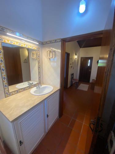a bathroom with a sink and a mirror at Casa Nova da Corte Salva in Grândola