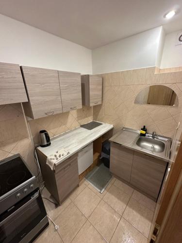 a small kitchen with a sink and a stove at Apartmány BRETZ in Vrbov