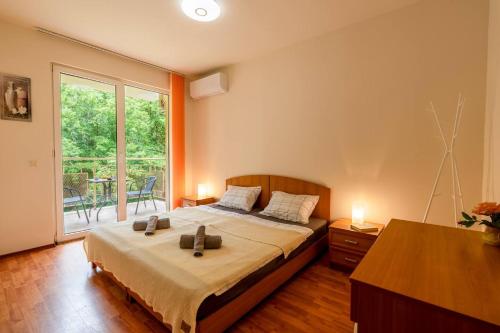 a bedroom with a bed with two pillows on it at Tranquil condo in Golden Sands in Varna City