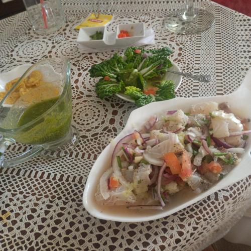 a table with a plate of food on a table at Backpack Cabin A 49149 in Oranjestad