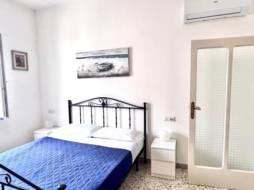 a bedroom with a bed with a blue comforter at Casa Aurora in Ravello